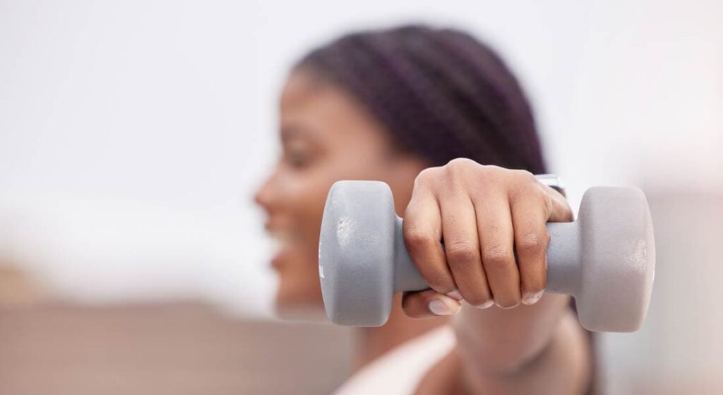 Woman lifting a dumbbell weight for exercise